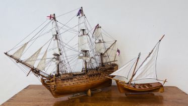 A MODEL WOODEN GALLEON LENGTH 80CM, HEIGHT 60CM AND A WOODEN SAILING BOAT MODEL LENGTH 43CM,