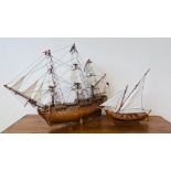 A MODEL WOODEN GALLEON LENGTH 80CM, HEIGHT 60CM AND A WOODEN SAILING BOAT MODEL LENGTH 43CM,