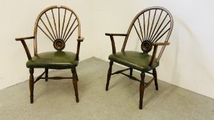 A PAIR OF HARDWOOD ELBOW CHAIRS WITH BOTTLE GREEN LEATHER UPHOLSTERED SEATS,