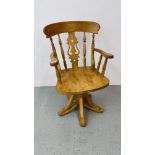 A HAND CRAFTED CAPTAIN STYLE PINE TOPPED SWIVEL CHAIR WITH FIDDLE BACK CARVING