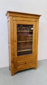 A LARGE SOLID OAK SHELVED CABINET WITH DRAWER TO BASE W 99CM, D 40CM, H 171CM.