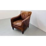 A GOOD QUALITY TAN LEATHER CLUB CHAIR WITH STUDDED DETAIL.