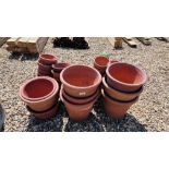 A COLLECTION OF 80 TERRACOTTA FLOWER POTS AND STANDS OF VARYING SIZES.