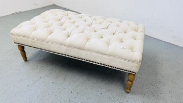 A LARGE CREAM CANVAS BUTTON BACK UPHOLSTERED FOOT STOOL 125CM X 70CM.