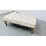 A LARGE CREAM CANVAS BUTTON BACK UPHOLSTERED FOOT STOOL 125CM X 70CM.