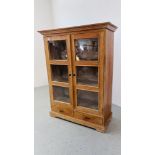 A PINE TWO DOOR SHELVED CABINET WITH TWO DRAWERS TO BASE W 111CM, D 50CM, H 150CM.