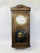 AN OAK CASED WALL CLOCK.