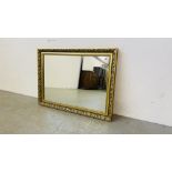 A MODERN GILT FRAMED WALL MIRROR 84CM. X 61CM.