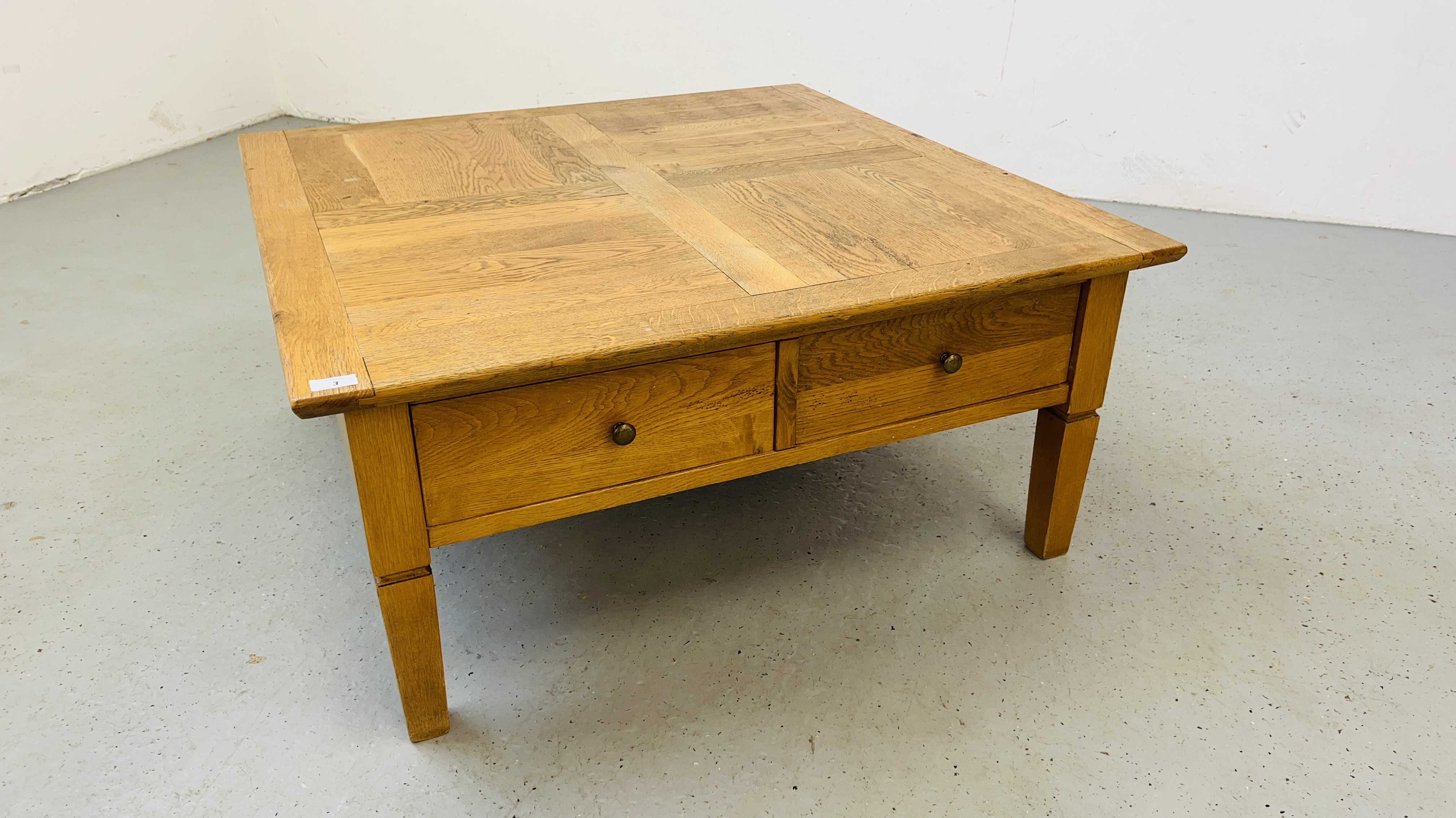 A SOLID OAK TWO DRAWER COFFEE TABLE W 100CM, D 100CM, H 46CM.