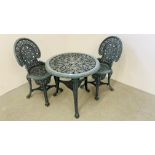 A DECORATIVE CAST IRON EFFECT PATIO TABLE AND TWO CHAIRS