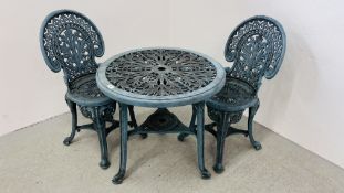 A DECORATIVE CAST IRON EFFECT PATIO TABLE AND 2 CHAIRS