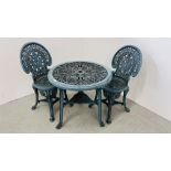 A DECORATIVE CAST IRON EFFECT PATIO TABLE AND 2 CHAIRS