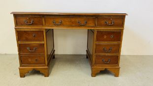 A REPRODUCTION YEW WOOD FINISH TWIN PEDESTAL DESK, THE TOP WITH GREEN TOOLED LEATHERETTE W 122CM,