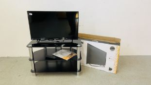 A BOXED BUSH 32" FLAT SCREEN TELEVISION WITH MODERN BLACK GLASS THREE TIER STAND WITH REMOTE AND