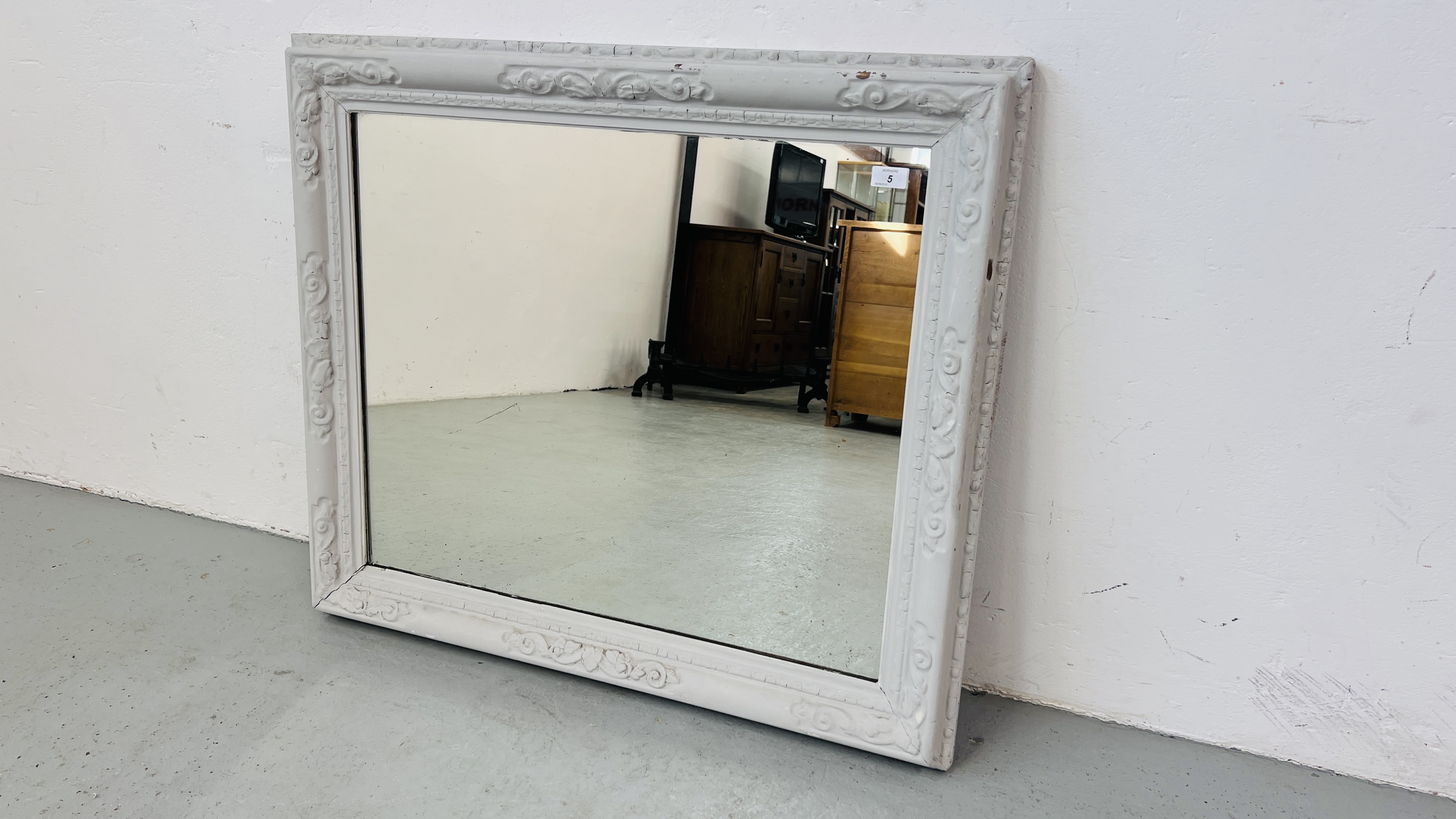 A RUSTIC STYLE RECTANGULAR WALL MIRROR IN PAINTED FRAME.