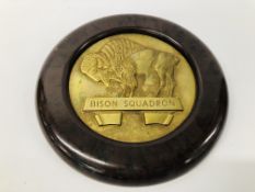 A HEAVY BRASS "BISON SQUADRON" PLAQUE IN CIRCULAR BAKELITE FRAME DIAMETER. OVERALL 22.5CM.