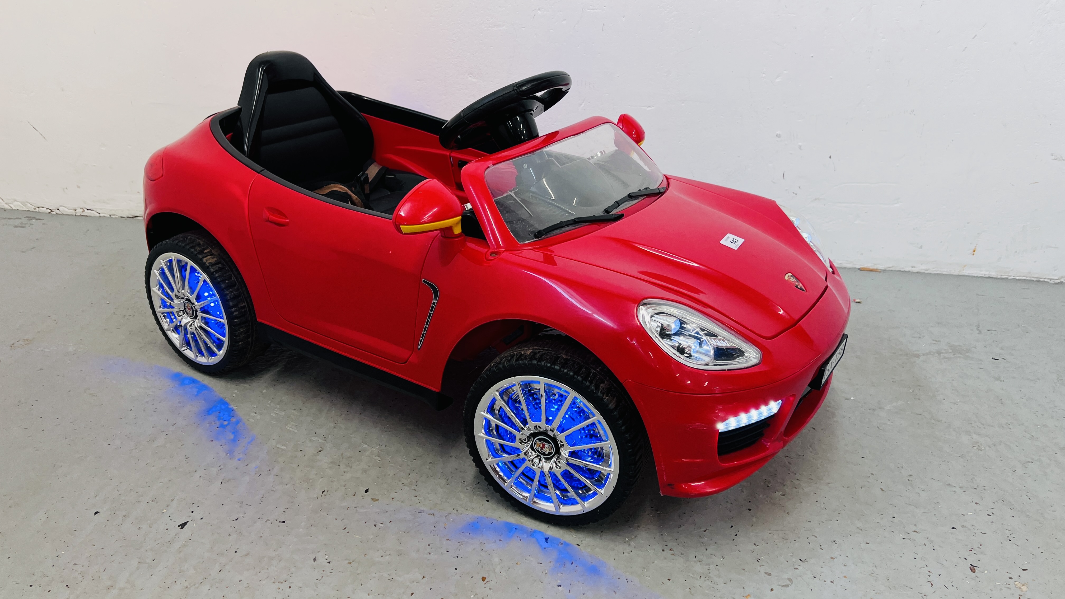 A BATTERY POWERED CHILD'S ELECTRIC CAR COMPLETE WITH CHARGER - SOLD AS SEEN.