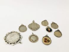 NINE ASSORTED SILVER MOUNTED COIN PENDANTS