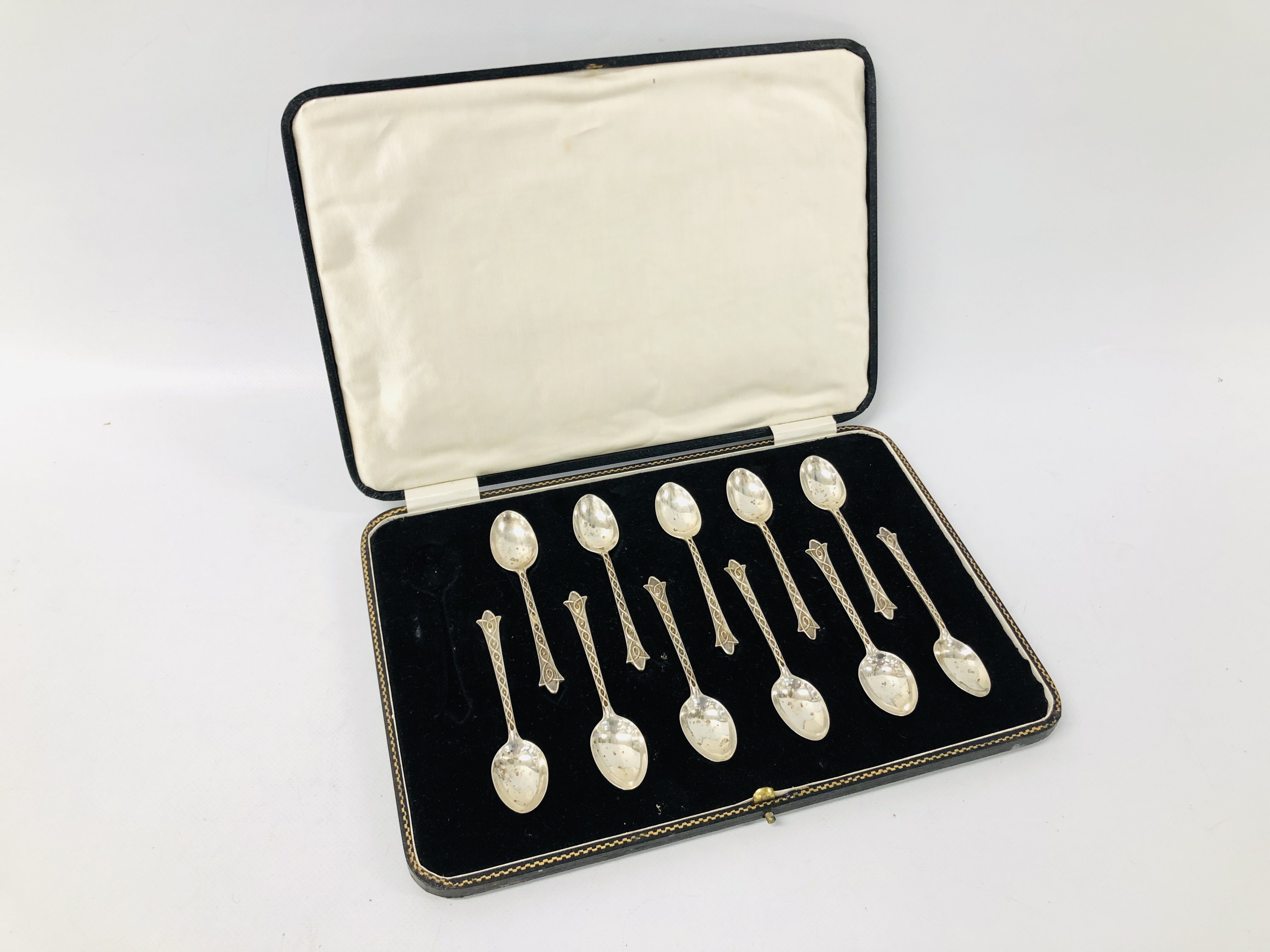 A CASE CONTAINING ELEVEN SILVER TEASPOONS STAMPED C.E.
