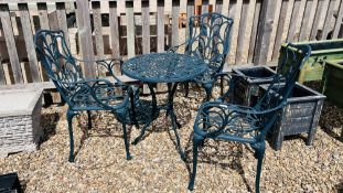 A METAL CRAFT GARDEN CIRCULAR TABLE AND THREE CHAIRS WITH PARASOL STAND AND CUSHIONS