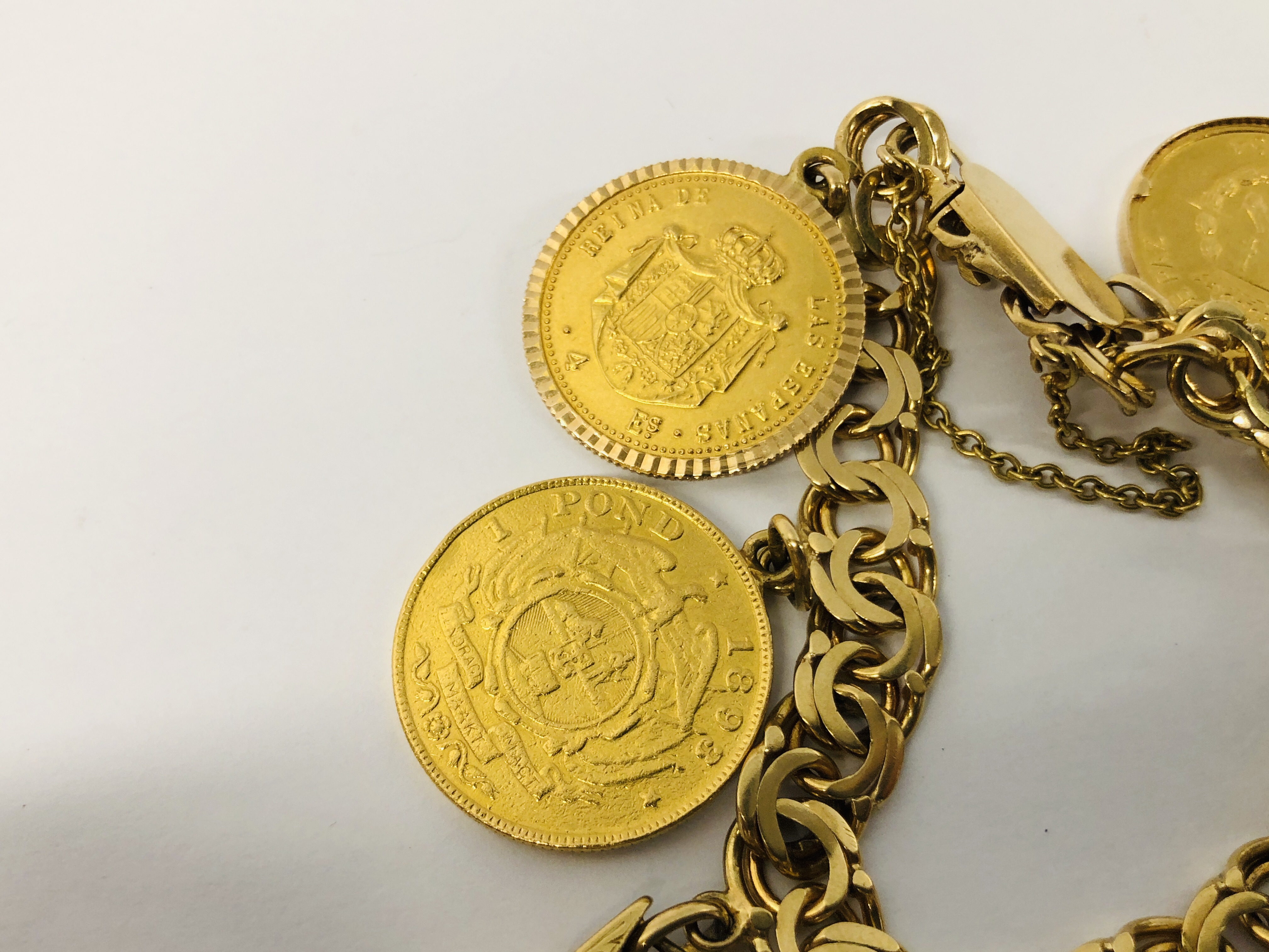 A YELLOW METAL BRACELET (CONTINENTAL MARKS) WITH NINE VARIOUS CHARMS/COINS ATTACHED TO INCLUDE :- - Image 7 of 11