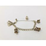 A SILVER CHARM BRACELET WITH FIVE ATTACHED CHARMS TO INCLUDE BIRD CAGE, WISHING WELL, CART ETC.