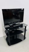 A PANASONIC VIERA 24 INCH TELEVISION COMPLETE WITH REMOTE AND MODERN BLACK GLASS STAND - SOLD AS