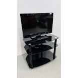 A PANASONIC VIERA 24 INCH TELEVISION COMPLETE WITH REMOTE AND MODERN BLACK GLASS STAND - SOLD AS