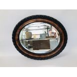 AN OVAL BEVEL PLATE WALL HANGING MIRROR 65CM. X 54CM.