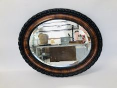 AN OVAL BEVEL PLATE WALL HANGING MIRROR 65CM. X 54CM.