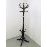 A MODERN REVOLVING STAINED COAT STAND H 200CM.