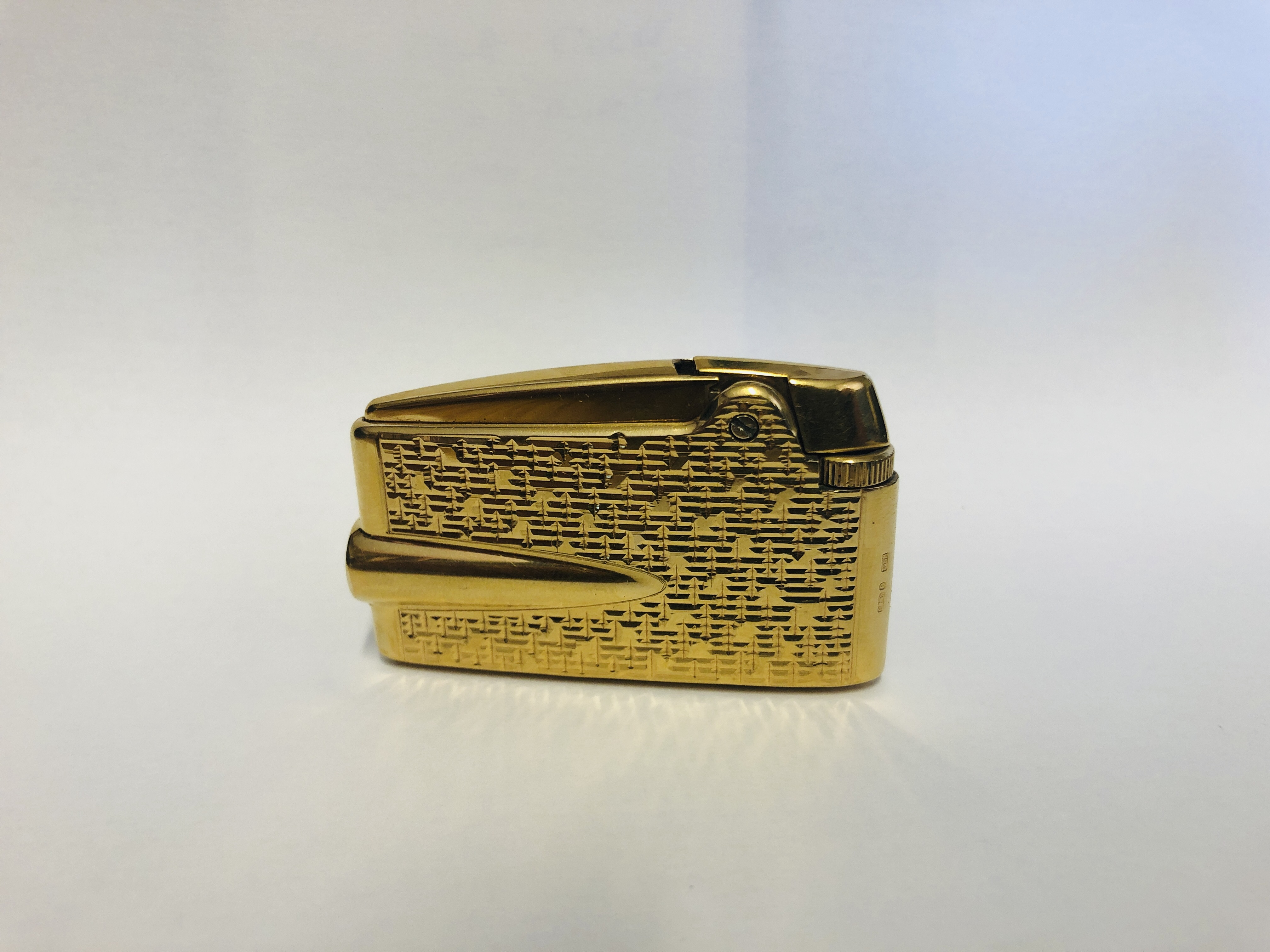 A RONSON ADONIS VARAFLAME GOLD FINISH POCKET CIGARETTE LIGHTER STAMPED "RPLD" AND "9.375".