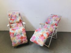 A PAIR OF GARDEN SUN RELAXER CHAIRS COMPLETE WITH PINK FLORAL CUSHIONS.