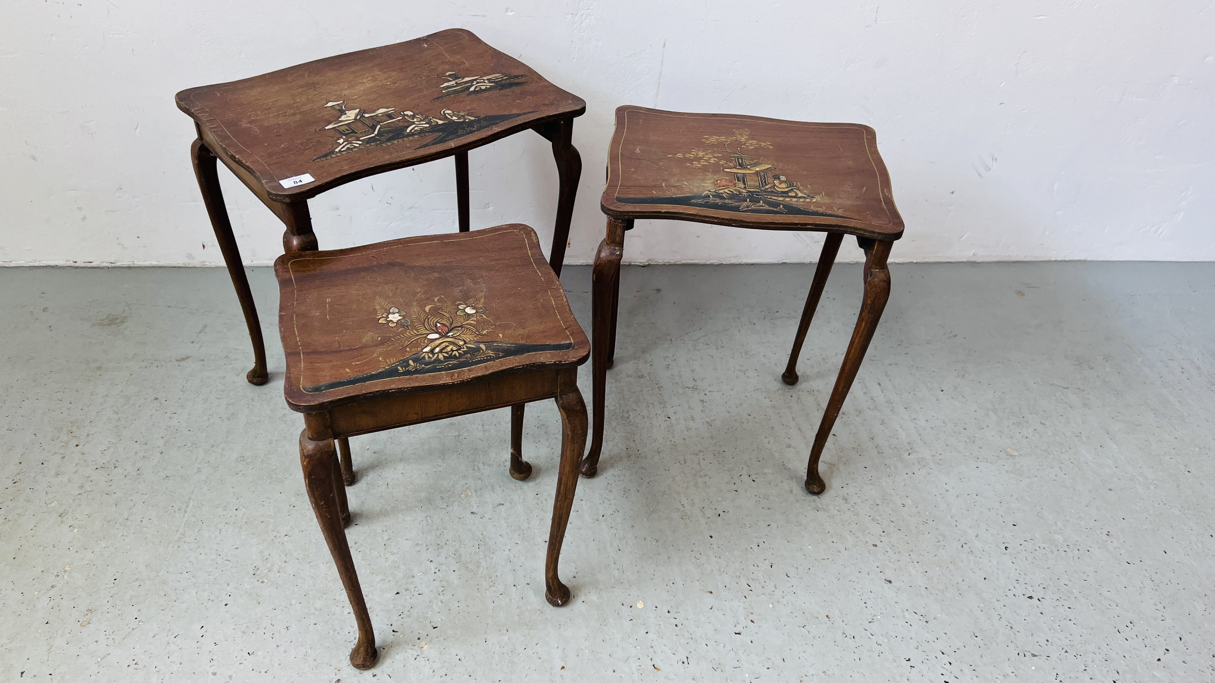 NEST OF THREE GRADUATED ORIENTAL DESIGN TABLES, HAND PAINTED LACQUERED DETAIL.