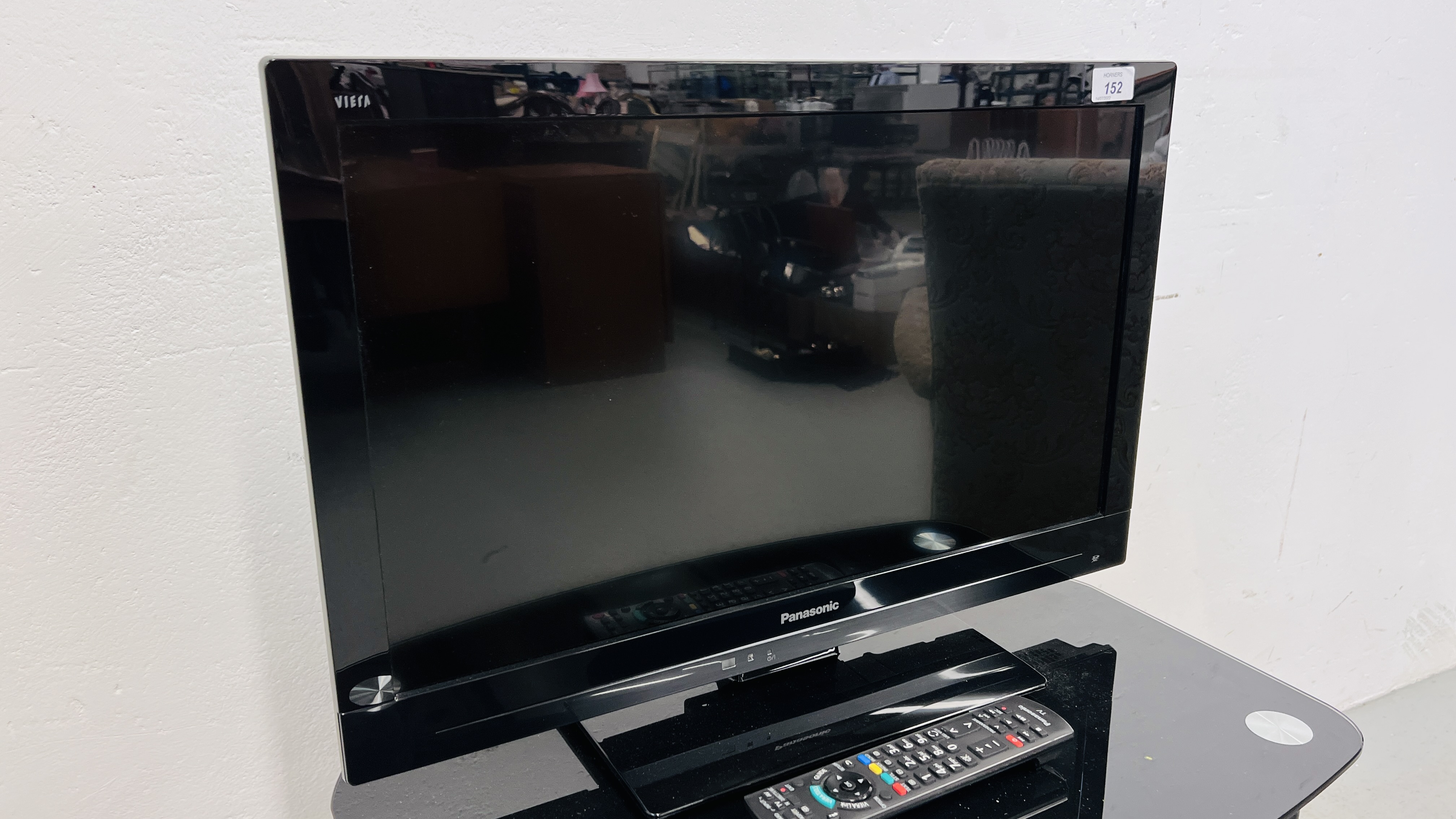 A PANASONIC VIERA 24 INCH TELEVISION COMPLETE WITH REMOTE AND MODERN BLACK GLASS STAND - SOLD AS - Image 2 of 5