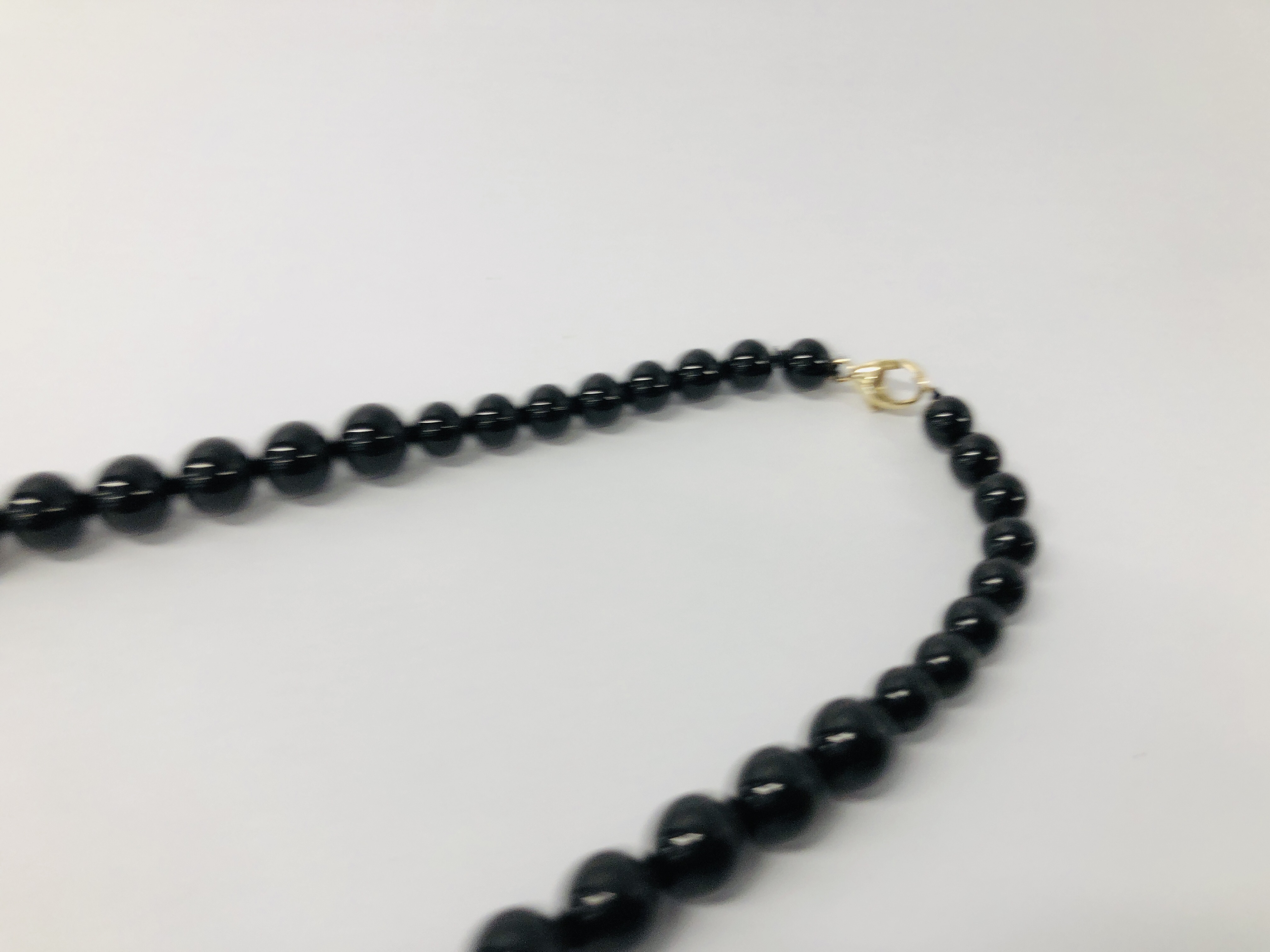 BLACK STONE CARVED NECKLACE WITH CLASP MARKED 585 (14K). - Image 3 of 5