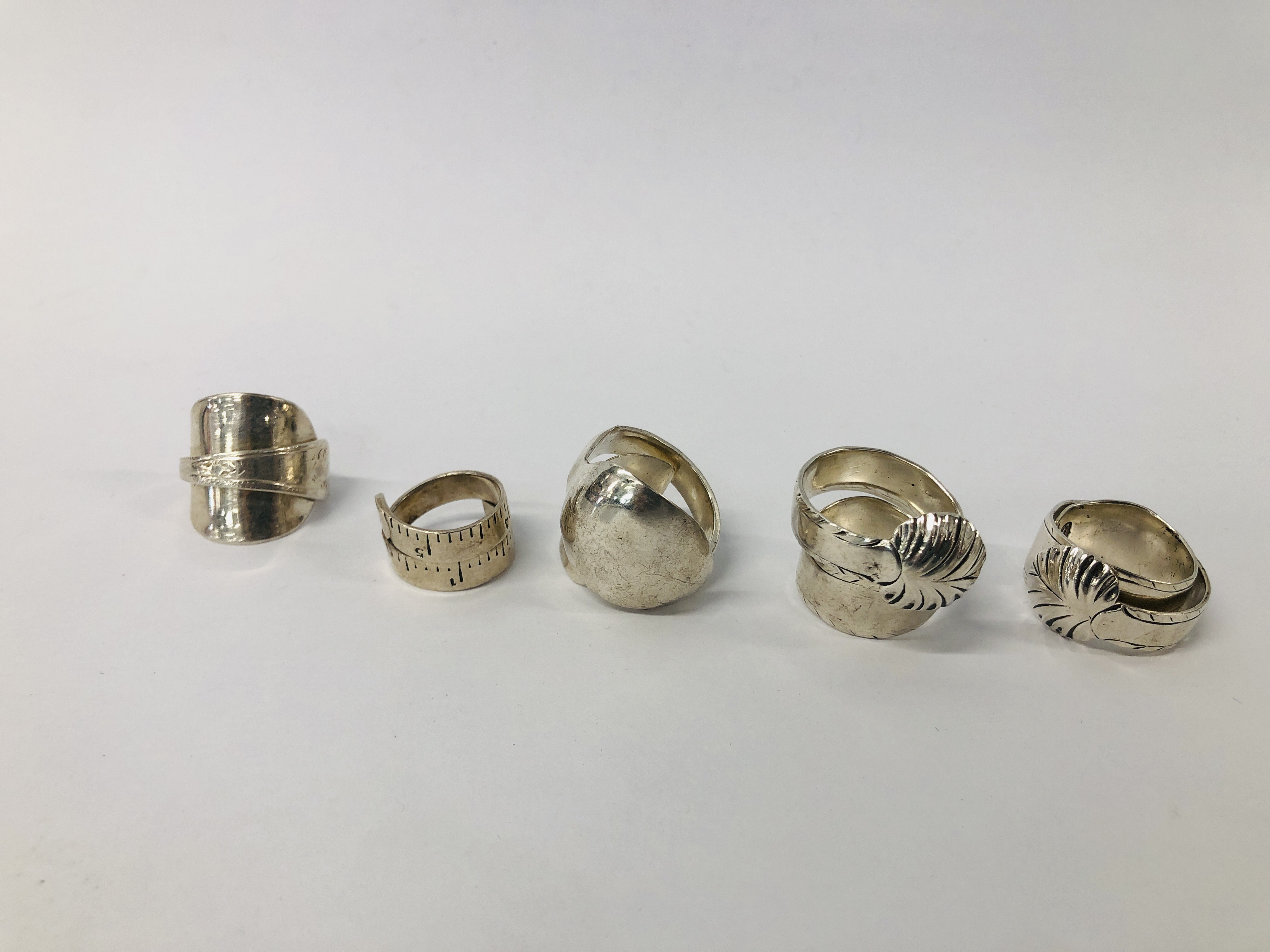 FIVE ASSORTED DESIGNER HAND CRAFTED SILVER RINGS