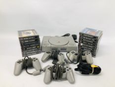A PLAY STATION 1 COMPLETE WITH THREE SONY PLAYSTATION CONTROLLERS AND A GAMESTER CONTROLLER WITH