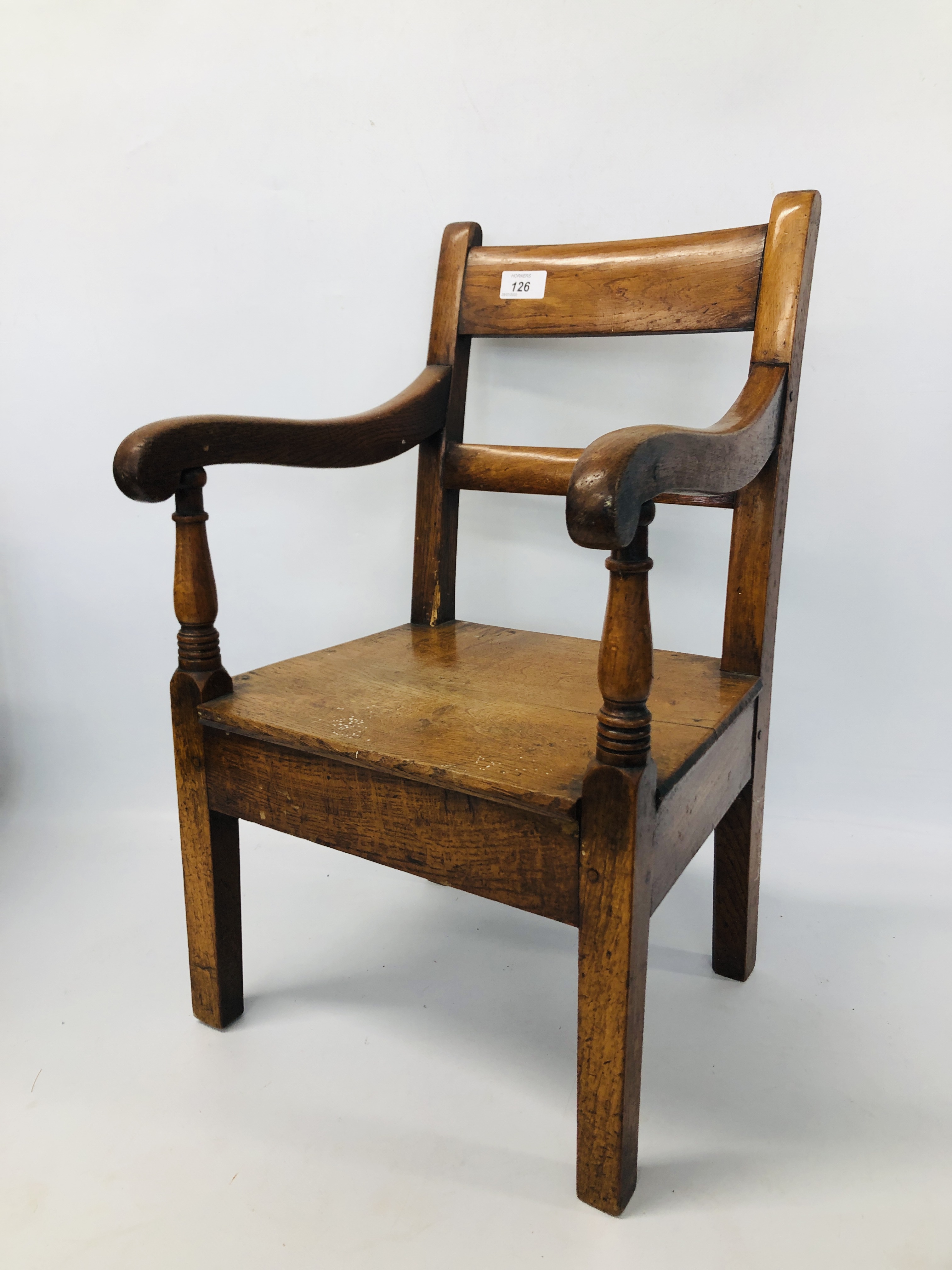 A CHILD'S OAK ELBOW CHAIR HEIGHT 57CM.