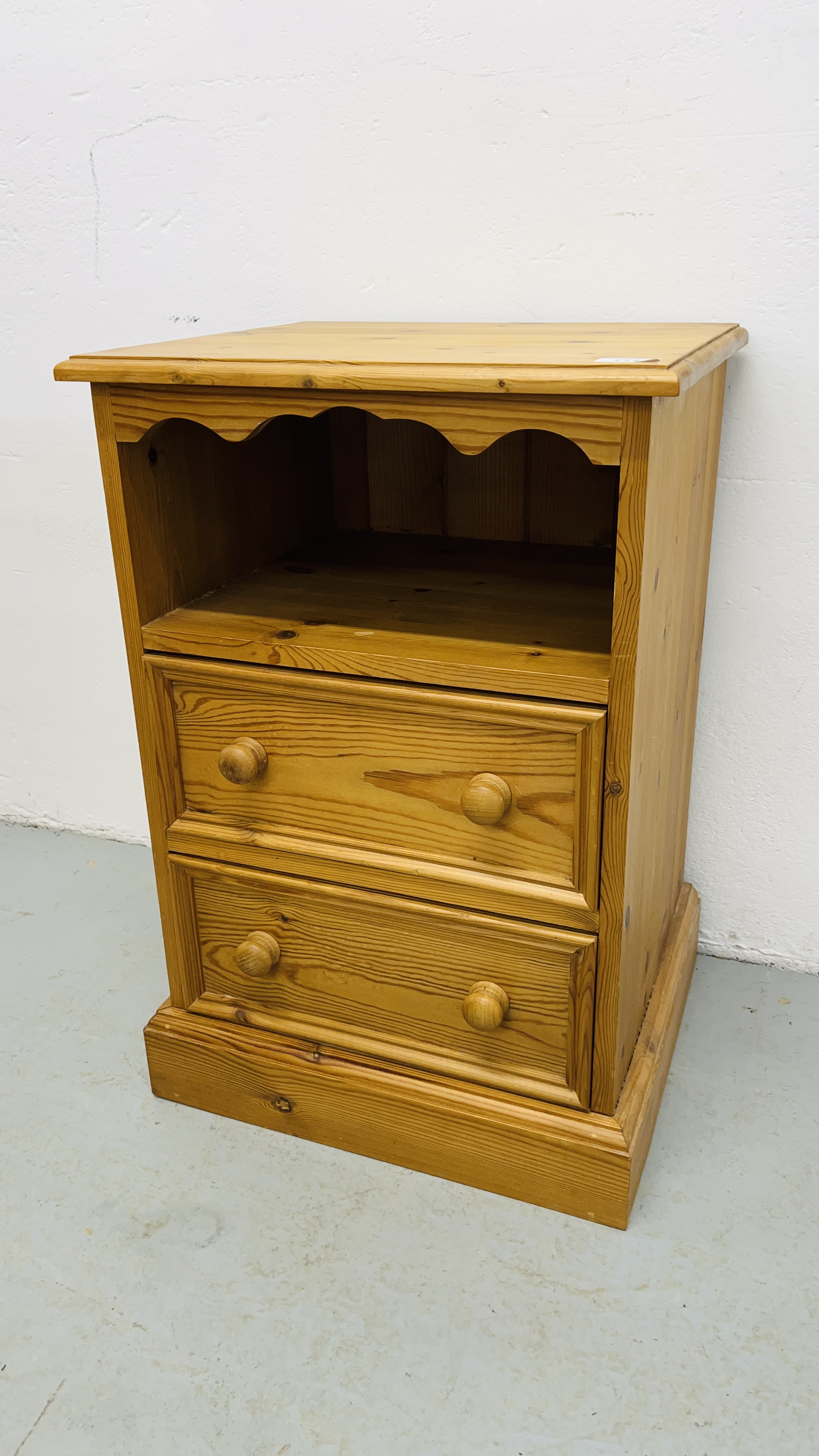 A WAXED PINE TWO DRAWER BEDSIDE CABINET WIDTH 45CM. DEPTH 38CM. HEIGHT 67CM.