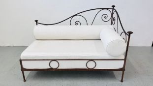 A FRENCH STYLE METALCRAFT CHAISE LOUNGE WITH CREAM UPHOLSTERED BASE AND BOLSTER CUSHIONS LENGTH