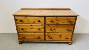 A HONEY PINE SIX DRAWER SIDE BY SIDE CHEST WIDTH 128CM. DEPTH 46CM. HEIGHT 77CM.