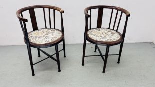 A PAIR OF EDWARDIAN TUB CHAIRS ON CROSS STRETCHER SUPPORT