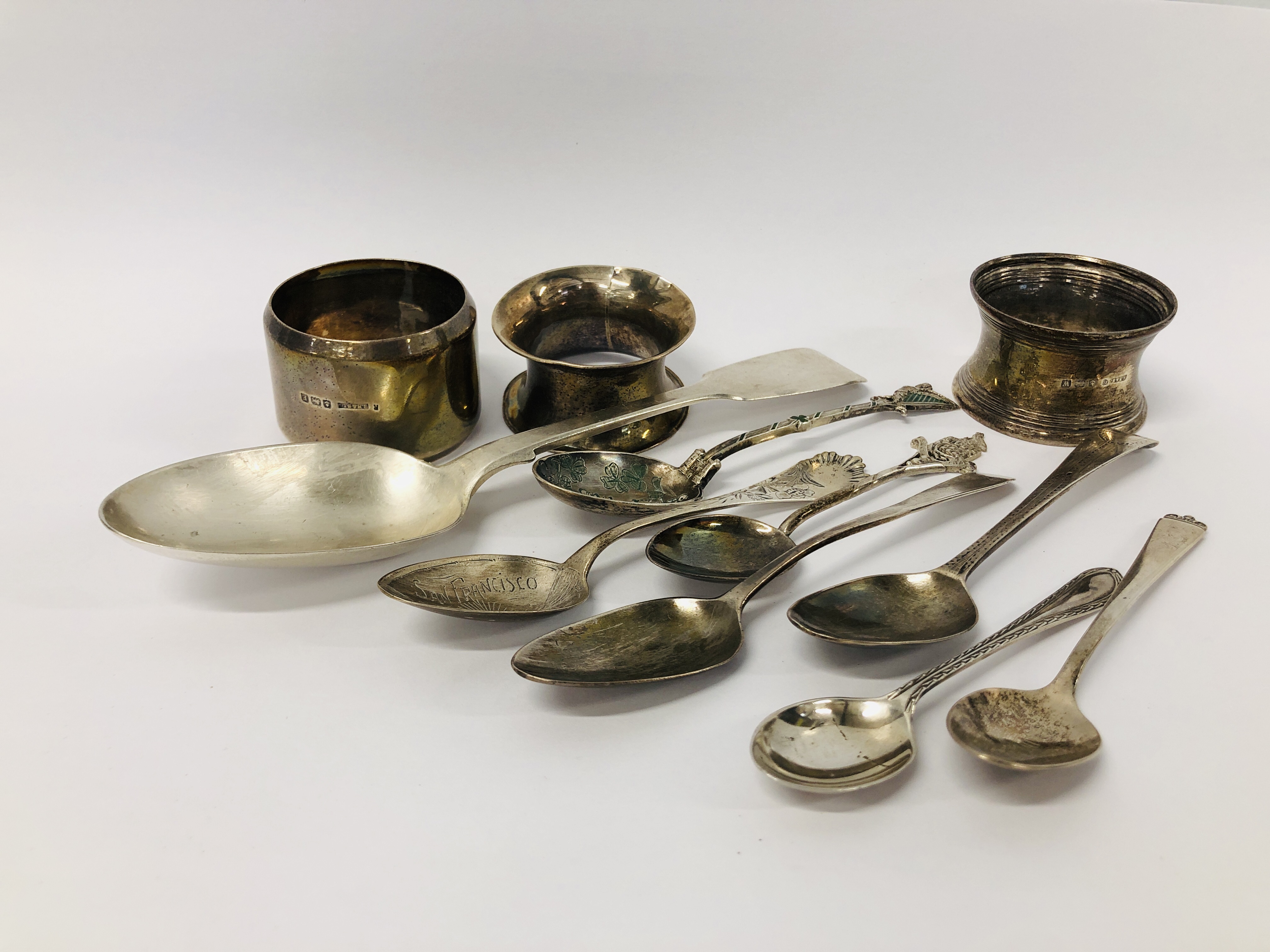 A GROUP OF 8 SILVER TEASPOONS TO INCLUDE GEORGIAN ALONG WITH THREE SILVER SERVIETTE RINGS