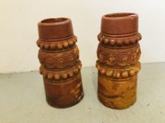 A PAIR OF TERRACOTTA CHIMNEY POTS WITH FLORAL RELIEF H 59CM.