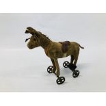 AN ANTIQUE STEIFF DONKEY ON WHEELS (HEIGHT TO TOP OF HEAD, 13.5CM).