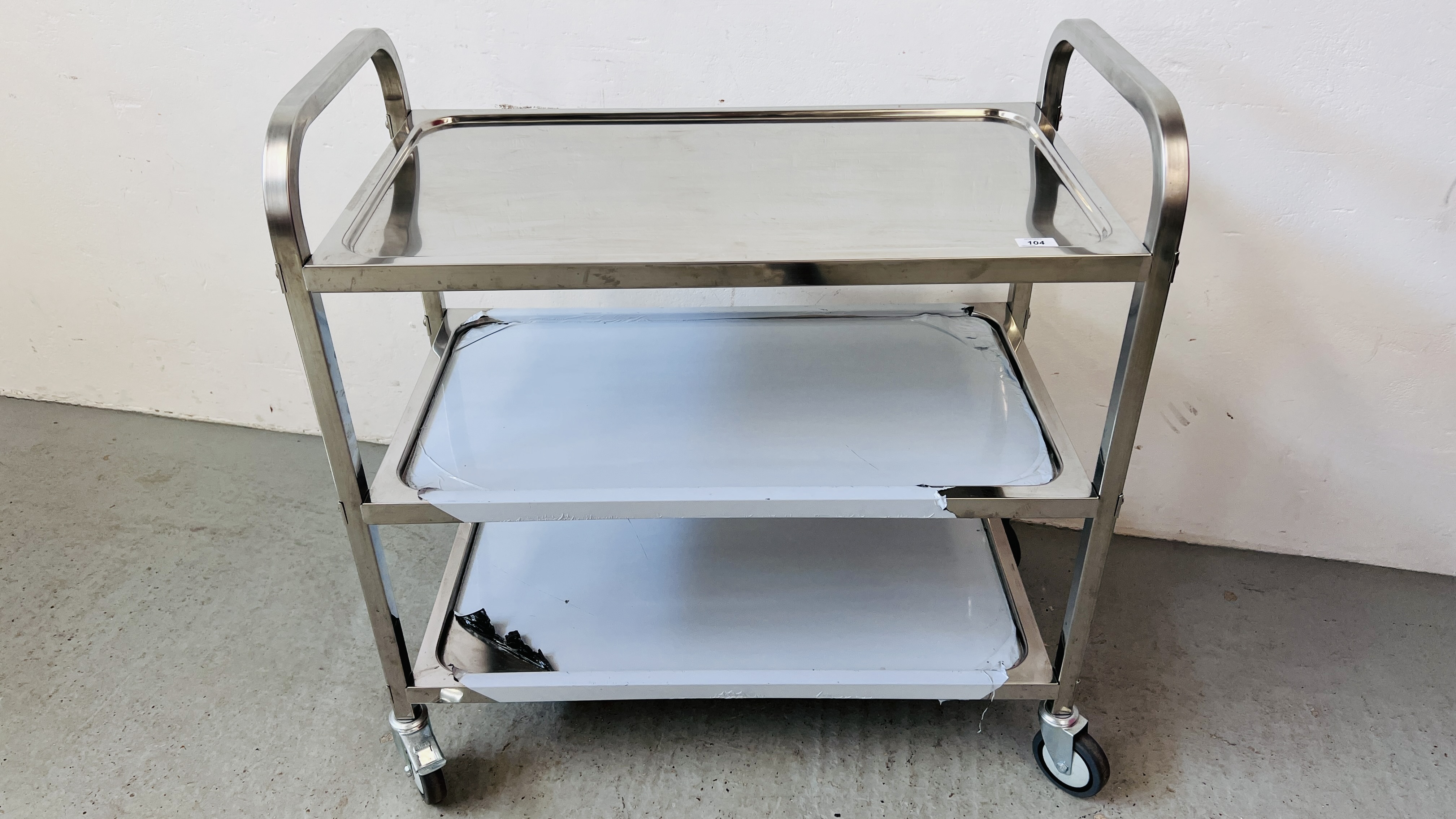 AN AS NEW STAINLESS STEEL WHEELED THREE TIER CATERING TROLLEY
