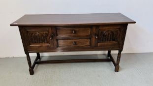 A REPRODUCTION OAK SIDEBOARD STANDING ON TURNED LEGS,