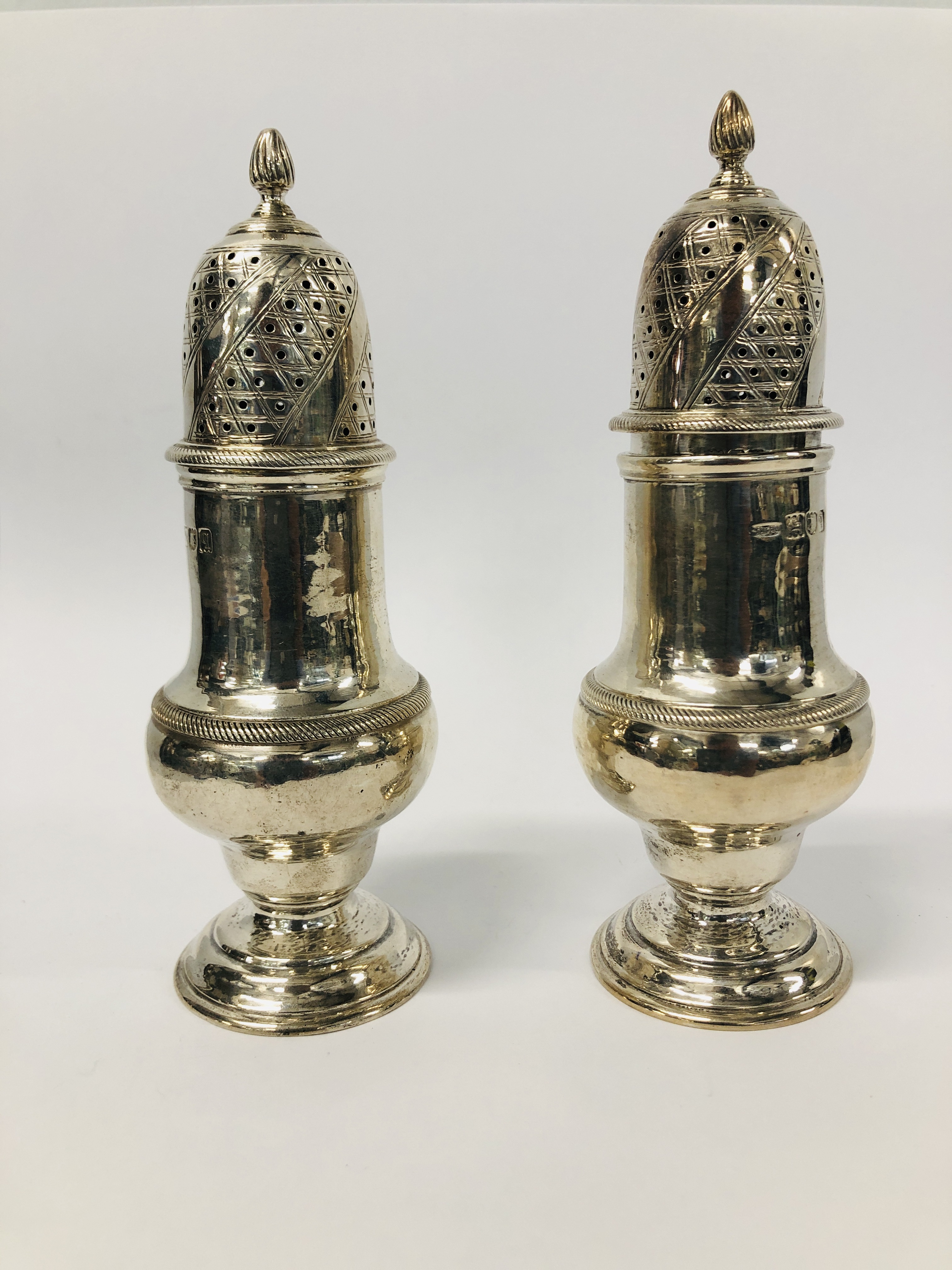 A PAIR OF GOOD QUALITY SILVER SIFTERS HEIGHT 13.5CM.