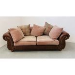 A MODERN THREE SEATER OATMEAL UPHOLSTERED SOFA WITH TAN LEATHER ARMS.